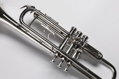 Photo of One trumpet on light background, top view