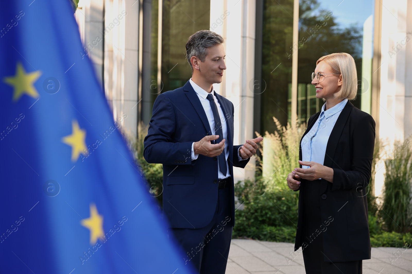 Photo of International relations. Diplomats talking during meeting outdoors