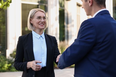 International relations. Diplomats shaking hands during meeting outdoors