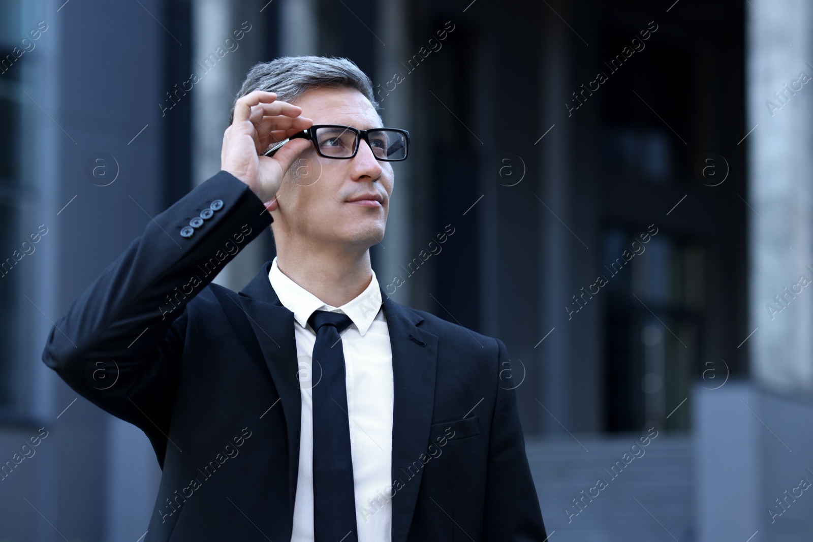 Photo of International relations. Diplomat with glasses in suit outdoors, space for text