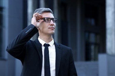 International relations. Diplomat with glasses in suit outdoors, space for text