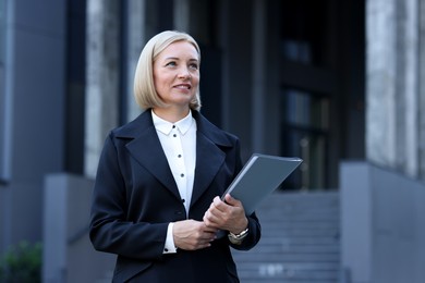 Photo of International relations. Diplomat with clipboard in suit outdoors, space for text