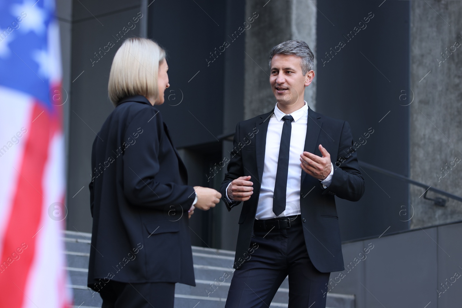 Photo of International relations. Diplomats talking during meeting outdoors