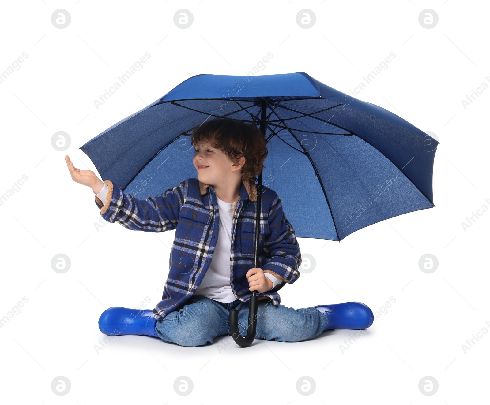 Photo of Little boy with blue umbrella on white background