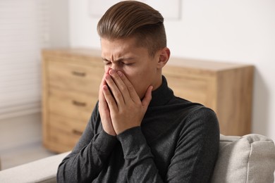 Photo of Young man suffering from sinusitis at home