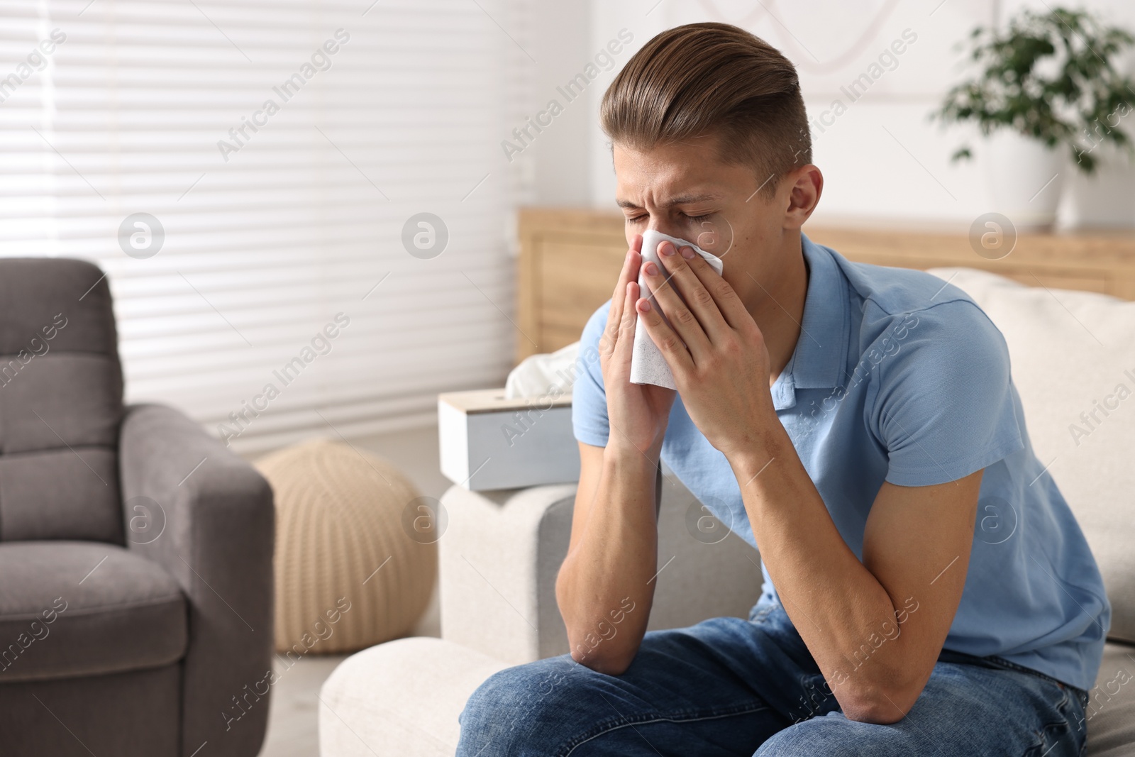 Photo of Young man with tissue suffering from sinusitis at home