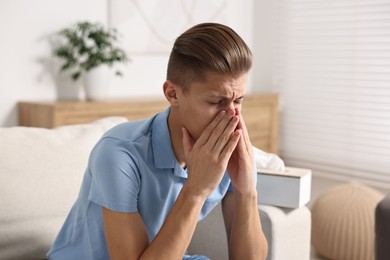 Photo of Young man suffering from sinusitis at home