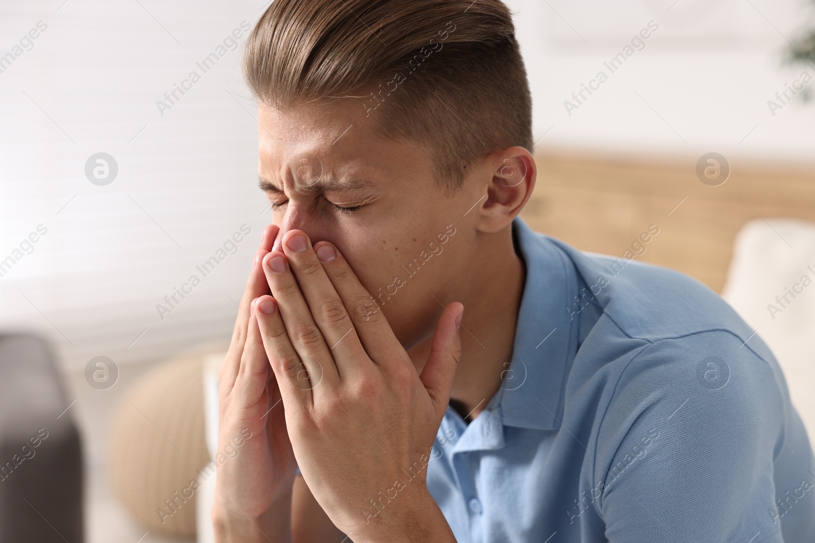 Photo of Young man suffering from sinusitis at home