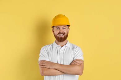 Engineer in hard hat on yellow background