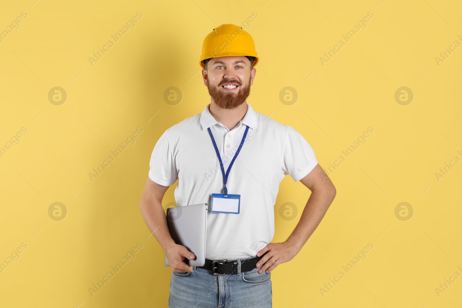 Photo of Engineer in hard hat on yellow background