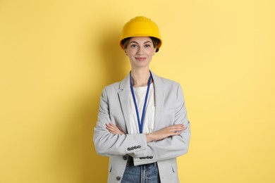 Photo of Engineer in hard hat on yellow background