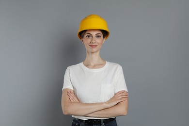 Photo of Engineer in hard hat on grey background