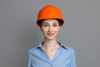 Engineer in hard hat on grey background