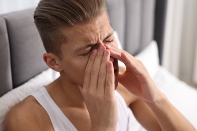 Photo of Young man suffering from sinusitis at home