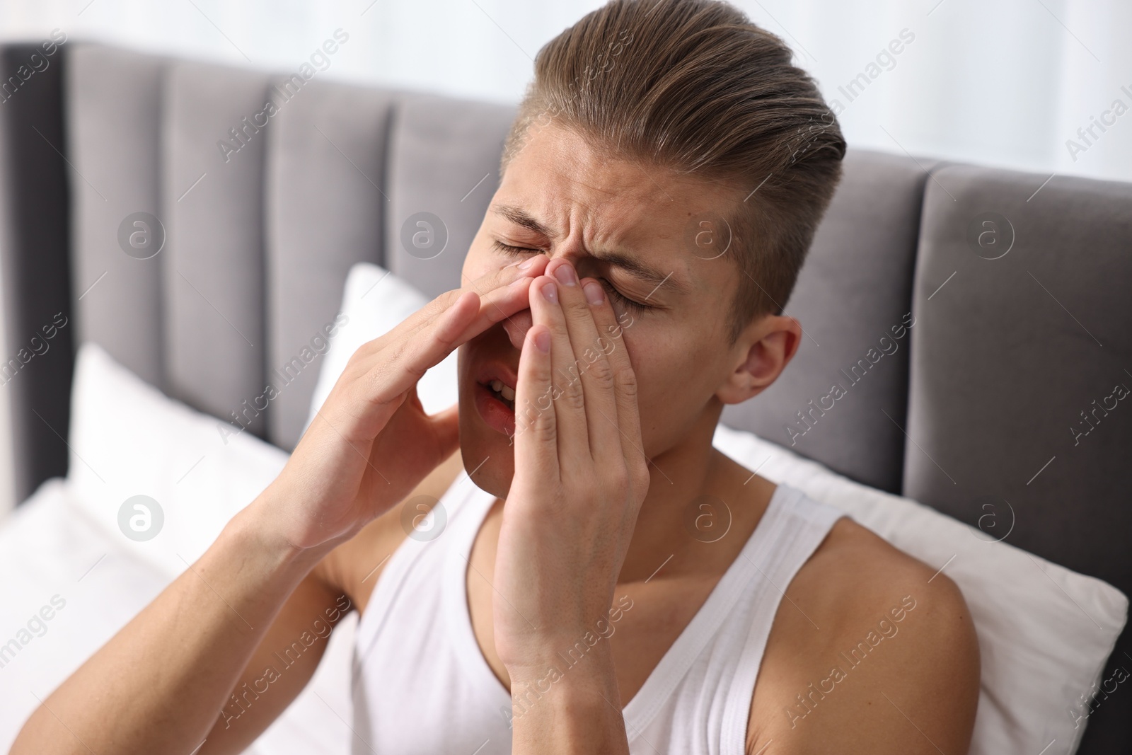 Photo of Young man suffering from sinusitis at home