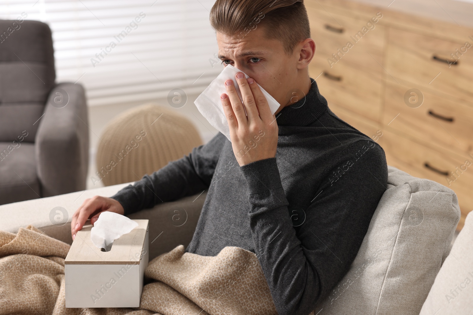 Photo of Young man with tissue suffering from sinusitis at home