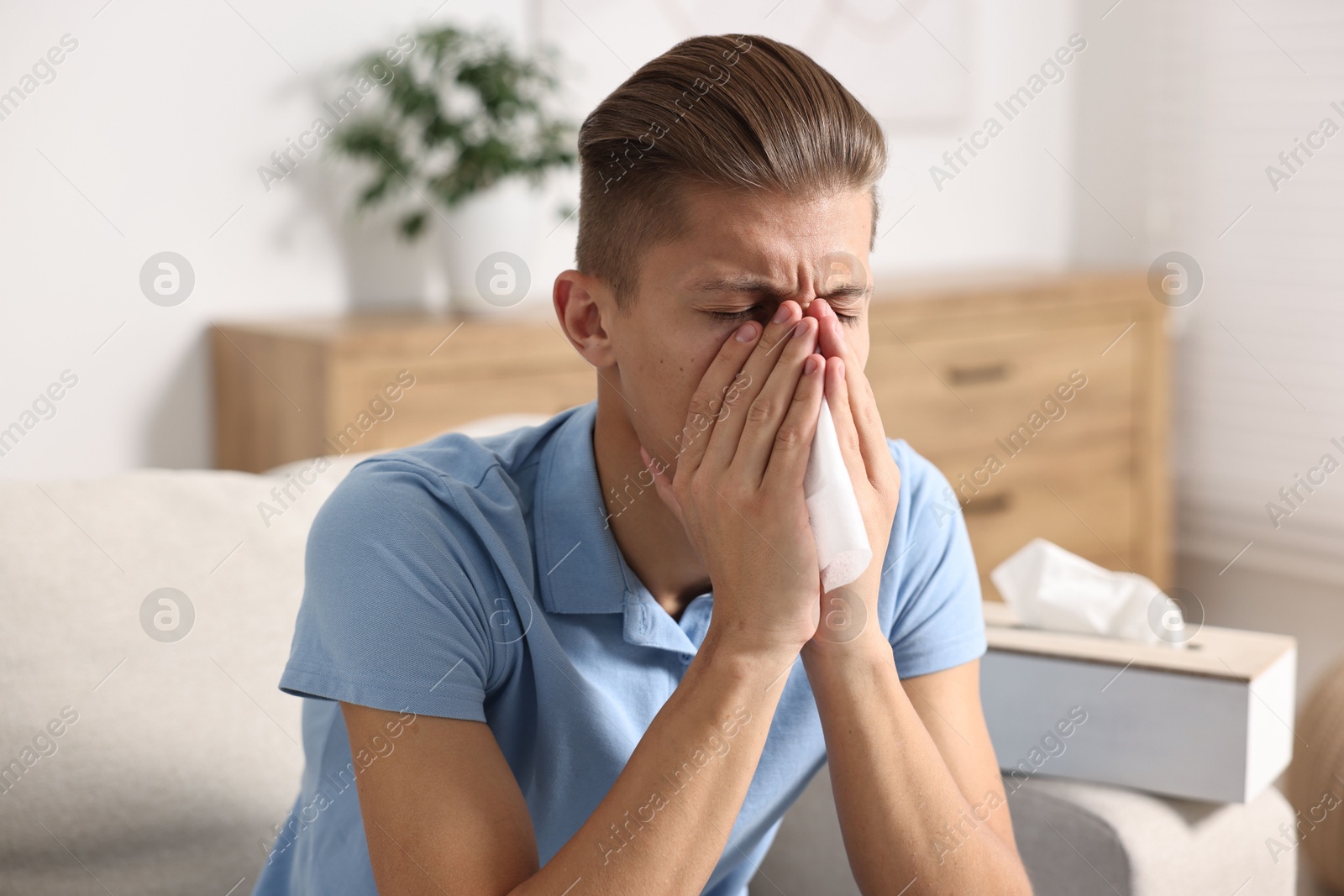 Photo of Young man with tissue suffering from sinusitis at home