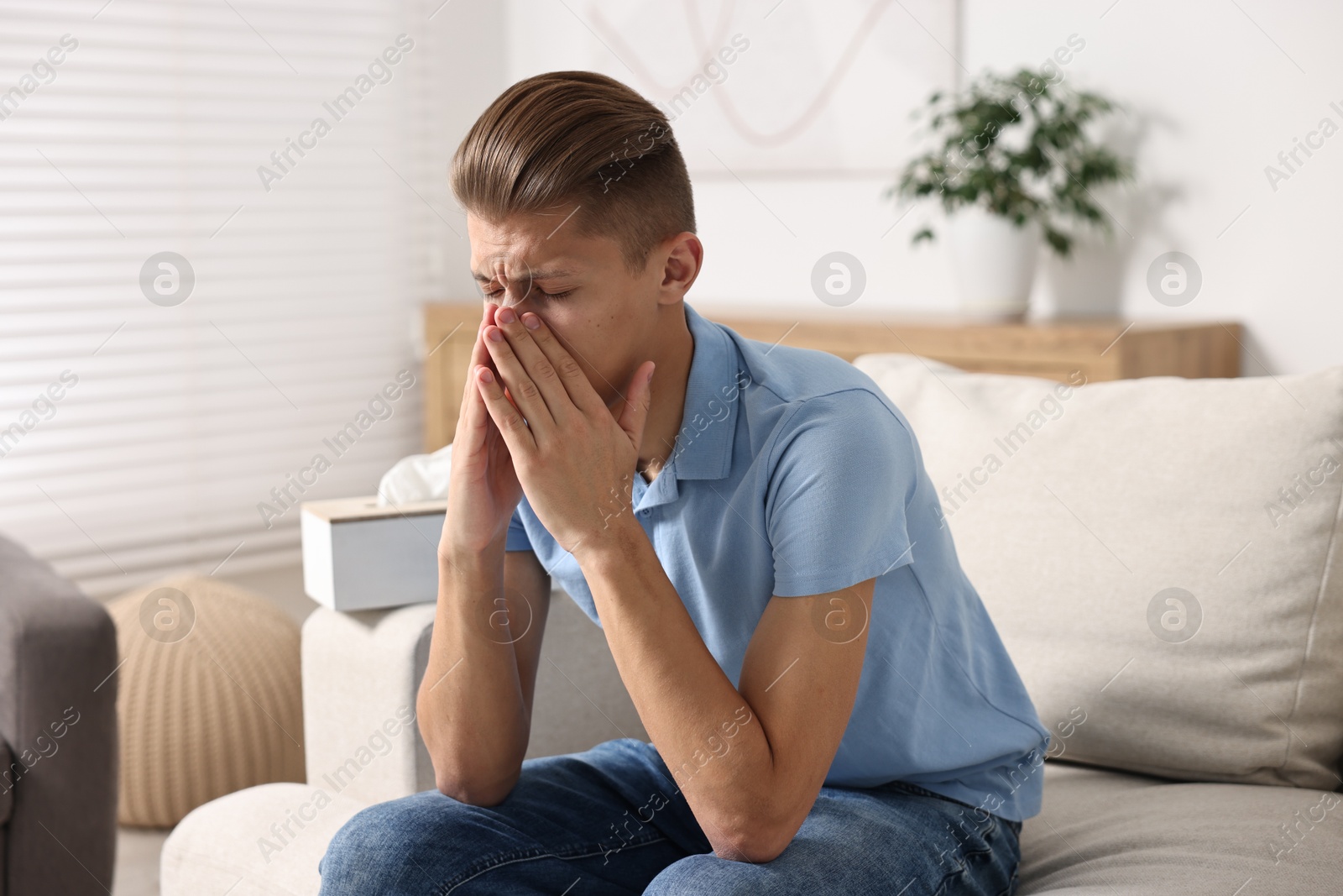 Photo of Young man suffering from sinusitis at home