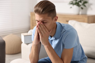 Young man suffering from sinusitis at home