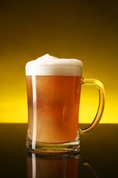 Photo of Glass of beer with froth on dark table, closeup