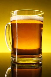 Glass of beer with froth on dark table, closeup