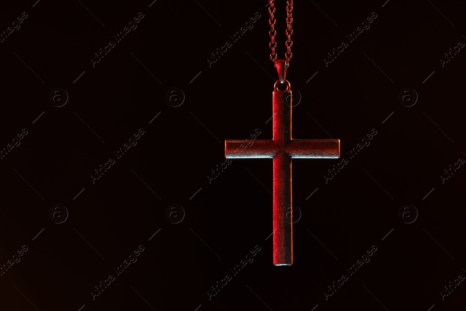 Photo of One cross with chain on black background, space for text. Religion of Christianity