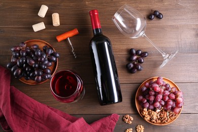 Photo of Flat lay composition with corkscrew and red wine on wooden table