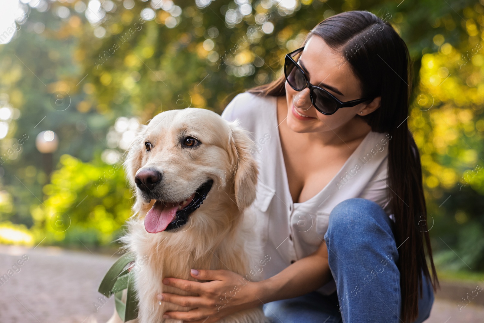 Photo of Portrait of happy owner with cute Golden Retriever dog outdoors