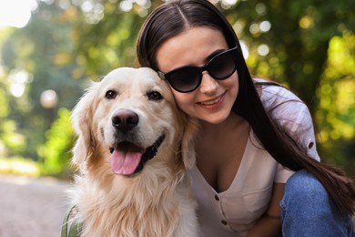 Photo of Portrait of happy owner with cute Golden Retriever dog outdoors