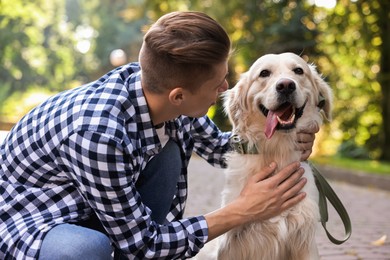 Photo of Owner with cute Golden Retriever dog outdoors