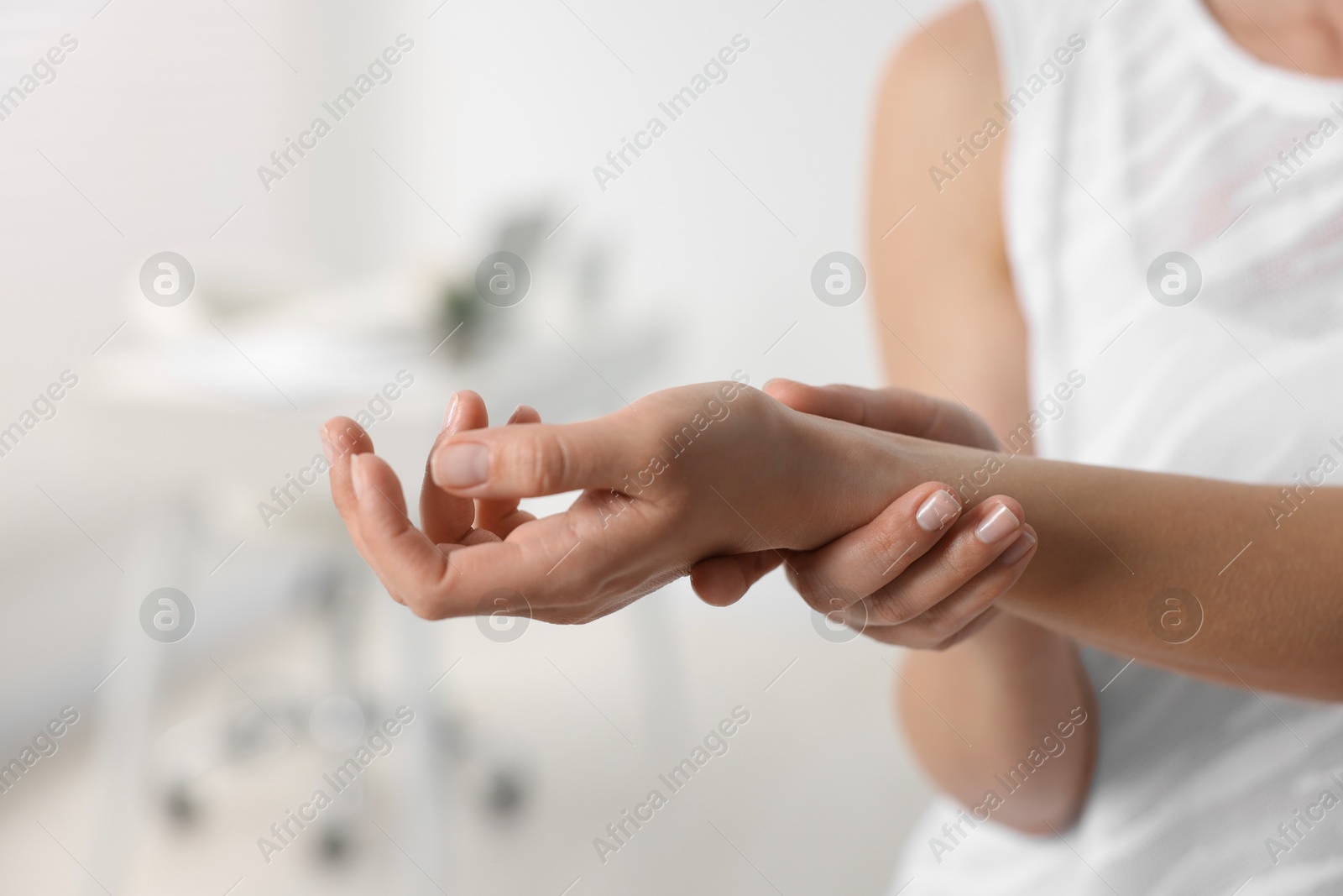 Photo of Sports injury. Woman with pain in wrist in hospital, closeup