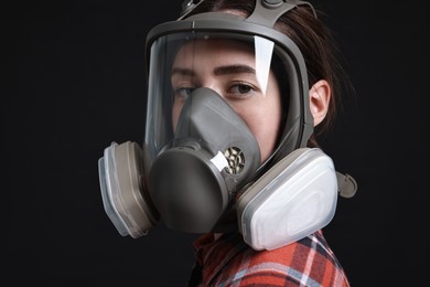 Photo of Woman in respirator mask on black background