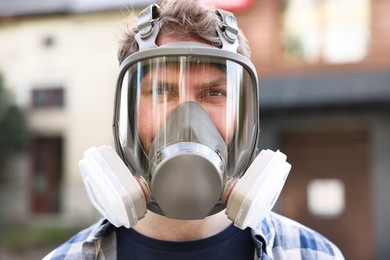 Photo of Man in respirator mask outdoors. Safety equipment