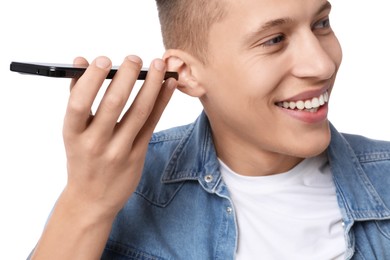 Photo of Young man with smartphone listening to voice message on white background