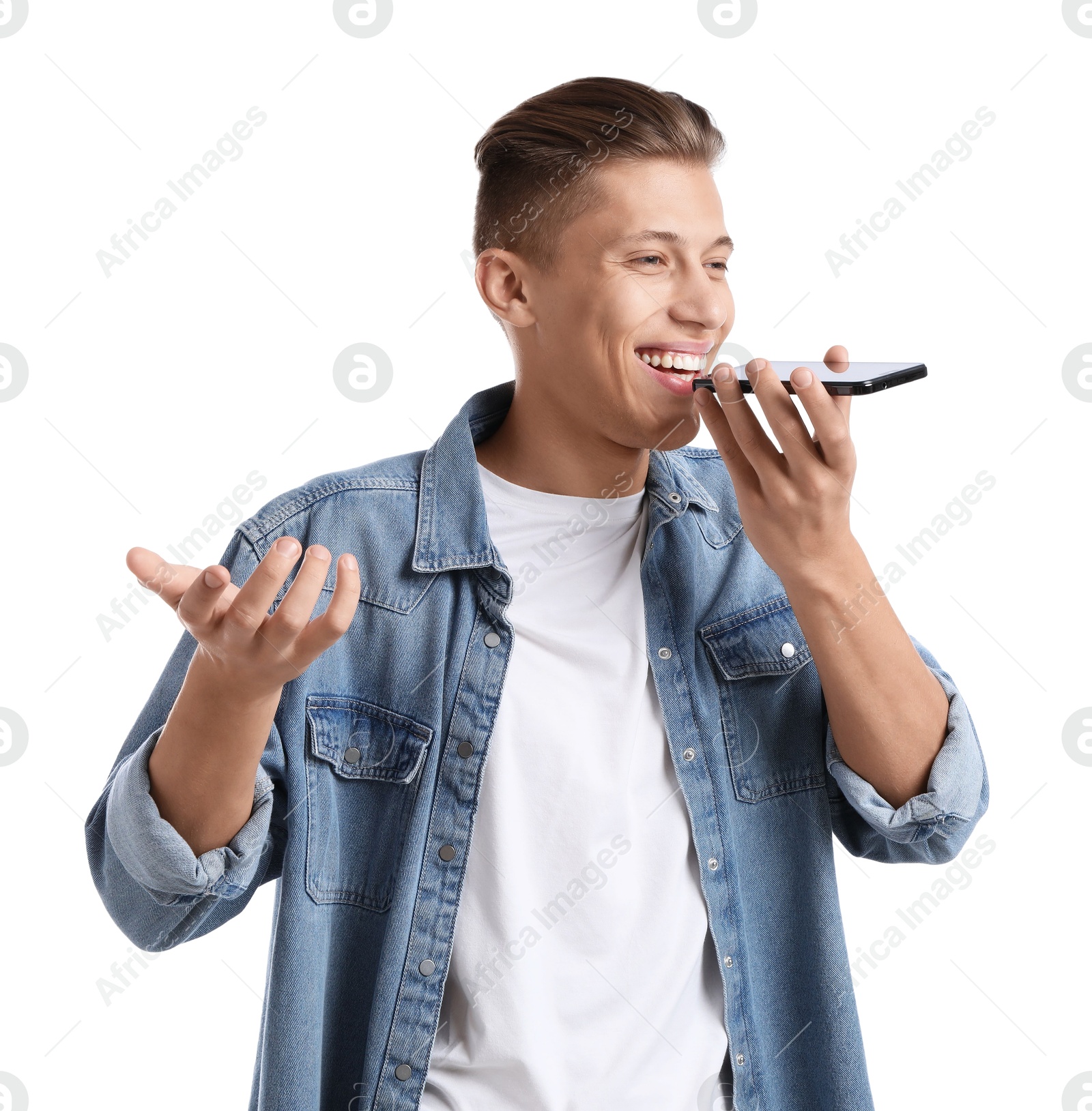 Photo of Young man recording voice message via smartphone on white background