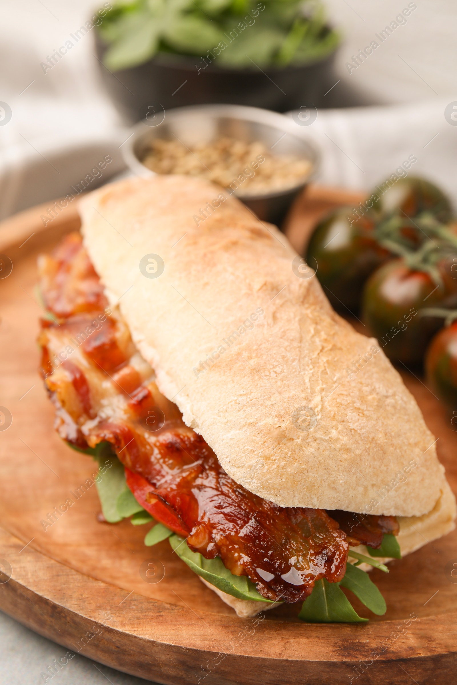 Photo of Tasty sandwich with bacon on grey table, closeup