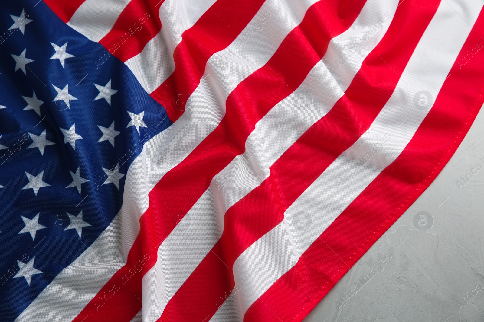 Photo of Flag of USA on light grey table, top view