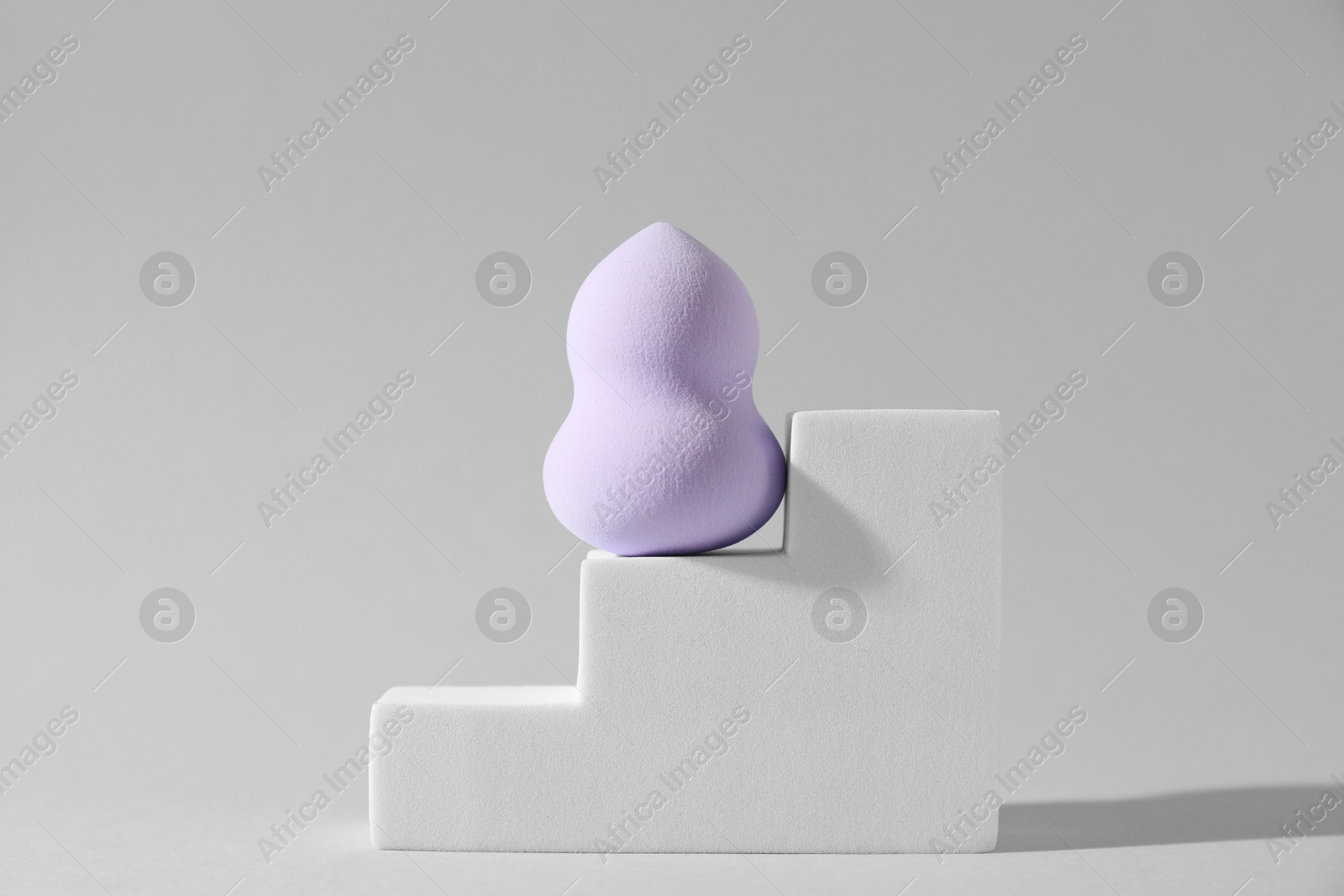 Photo of Stylish presentation of makeup sponge on light grey background