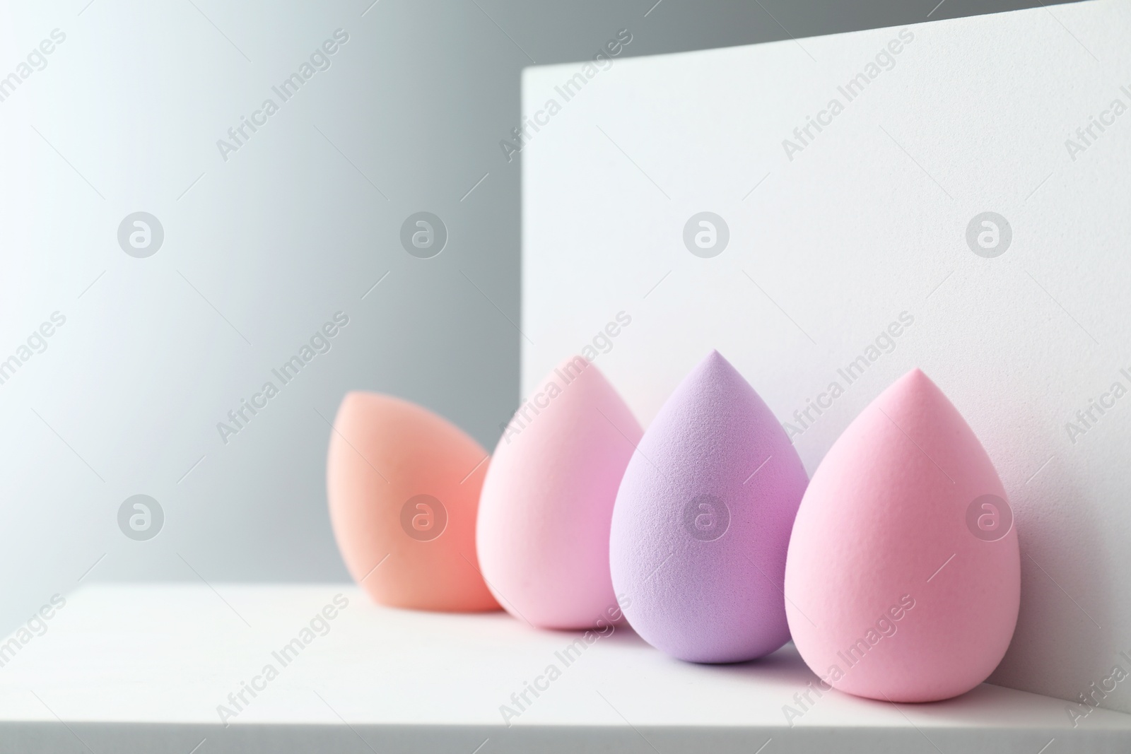 Photo of Stylish presentation of makeup sponges on light grey background