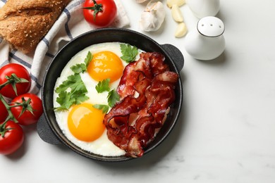 Tasty bacon with eggs and products on light table, flat lay