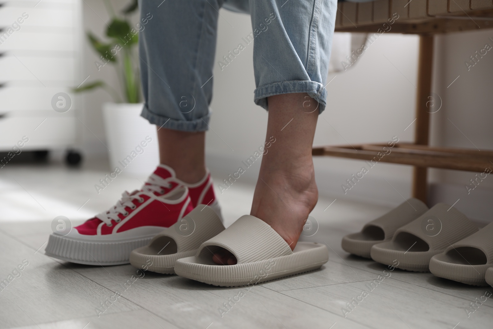 Photo of Woman changing into slippers at home, closeup