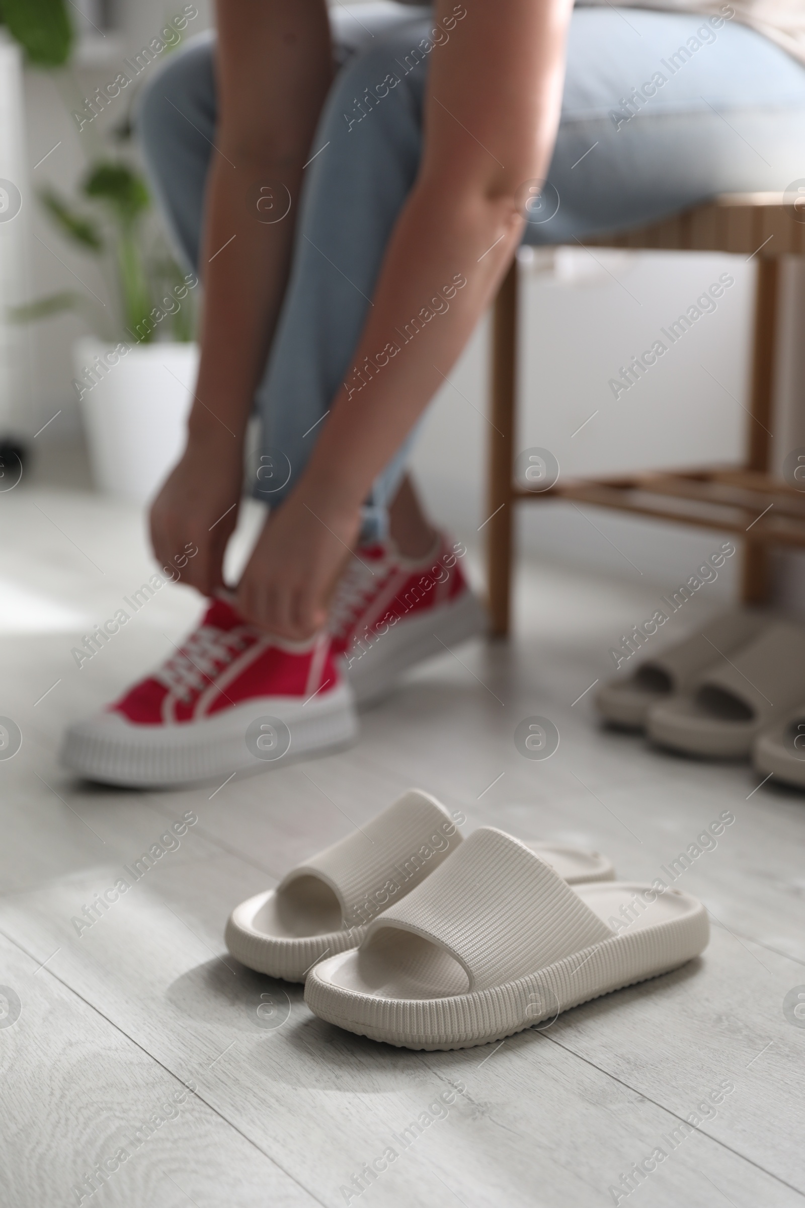 Photo of Woman changing into slippers at home, closeup