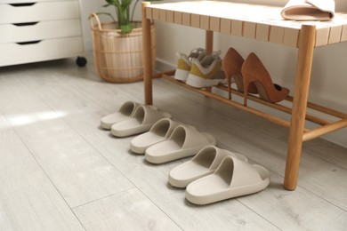 Many pairs of slippers in entryway at home