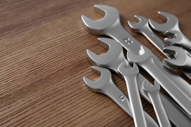 Photo of Auto mechanic's tools on wooden table, closeup. Space for text