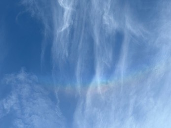 Photo of Beautiful blue sky with rainbow, low angle view