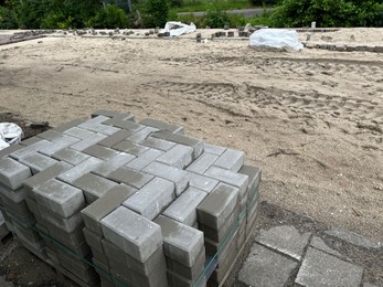 Photo of Process of laying paving stone blocks outdoors