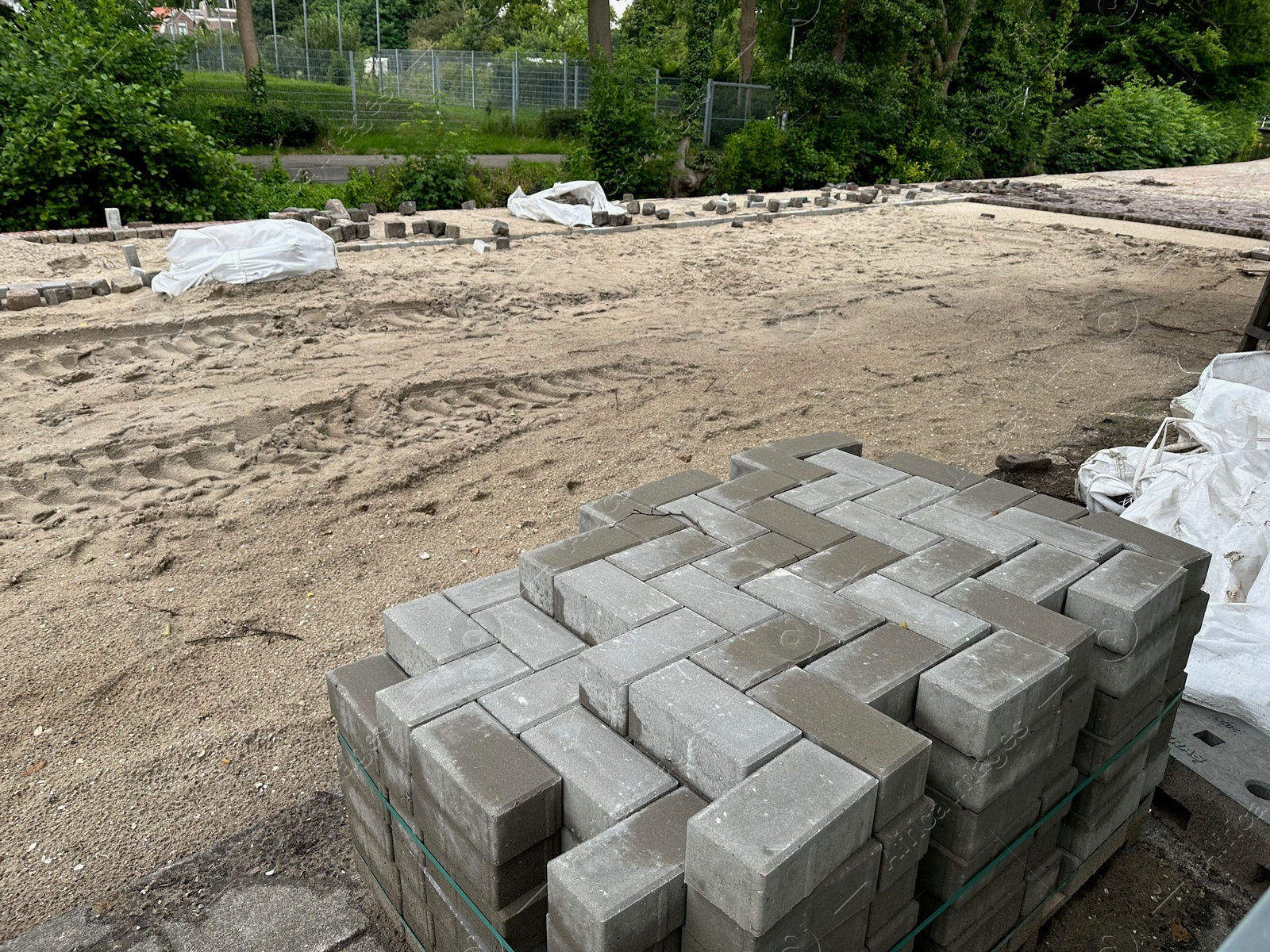 Photo of Process of laying paving stone blocks outdoors