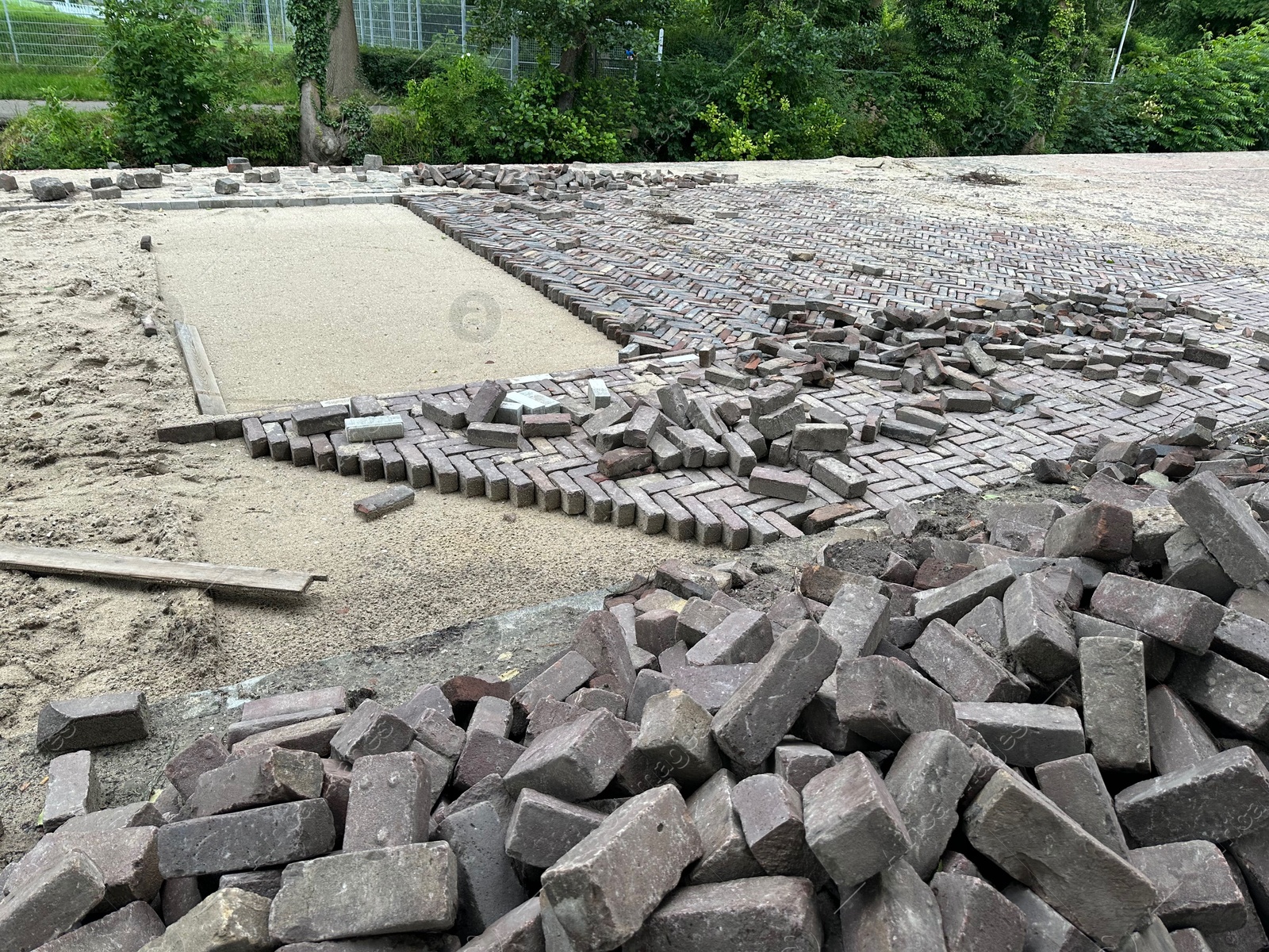 Photo of Process of laying paving stone blocks outdoors