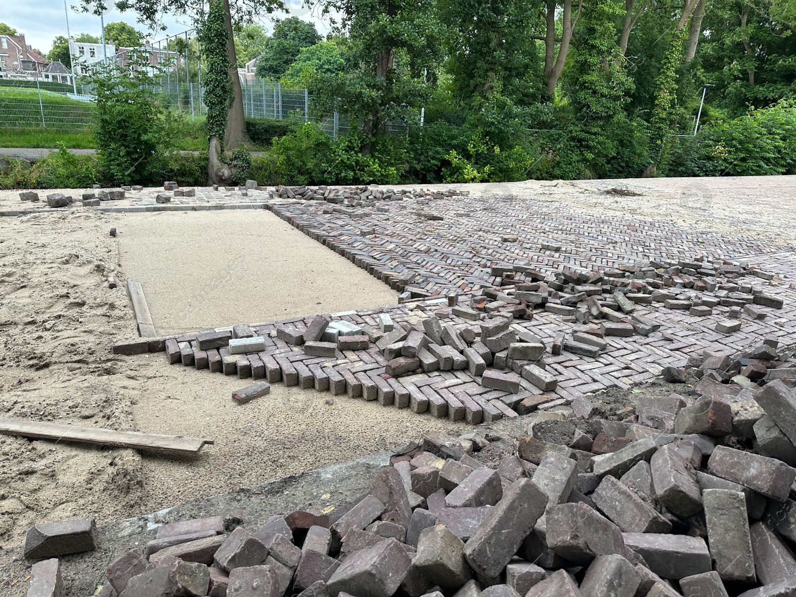 Photo of Process of laying paving stone blocks outdoors