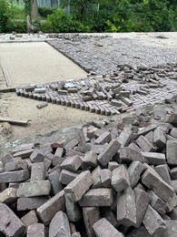 Photo of Process of laying paving stone blocks outdoors